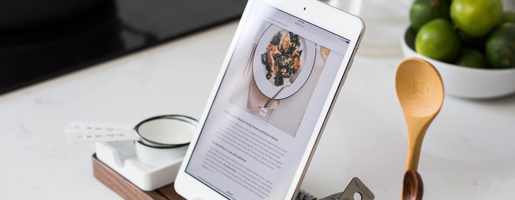 recipe displayed on tablet sitting in dock on kitchen counter