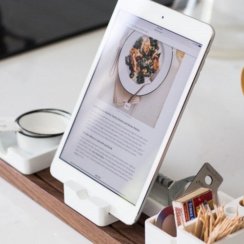 Kitchen recipe displayed on tablet sitting in dock on kitchen counter
